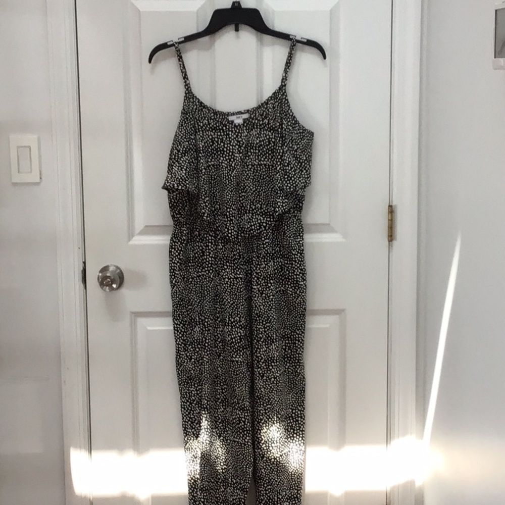 Spaghetti strap, black print jumpsuit with flounce on front top.  Sizelarge